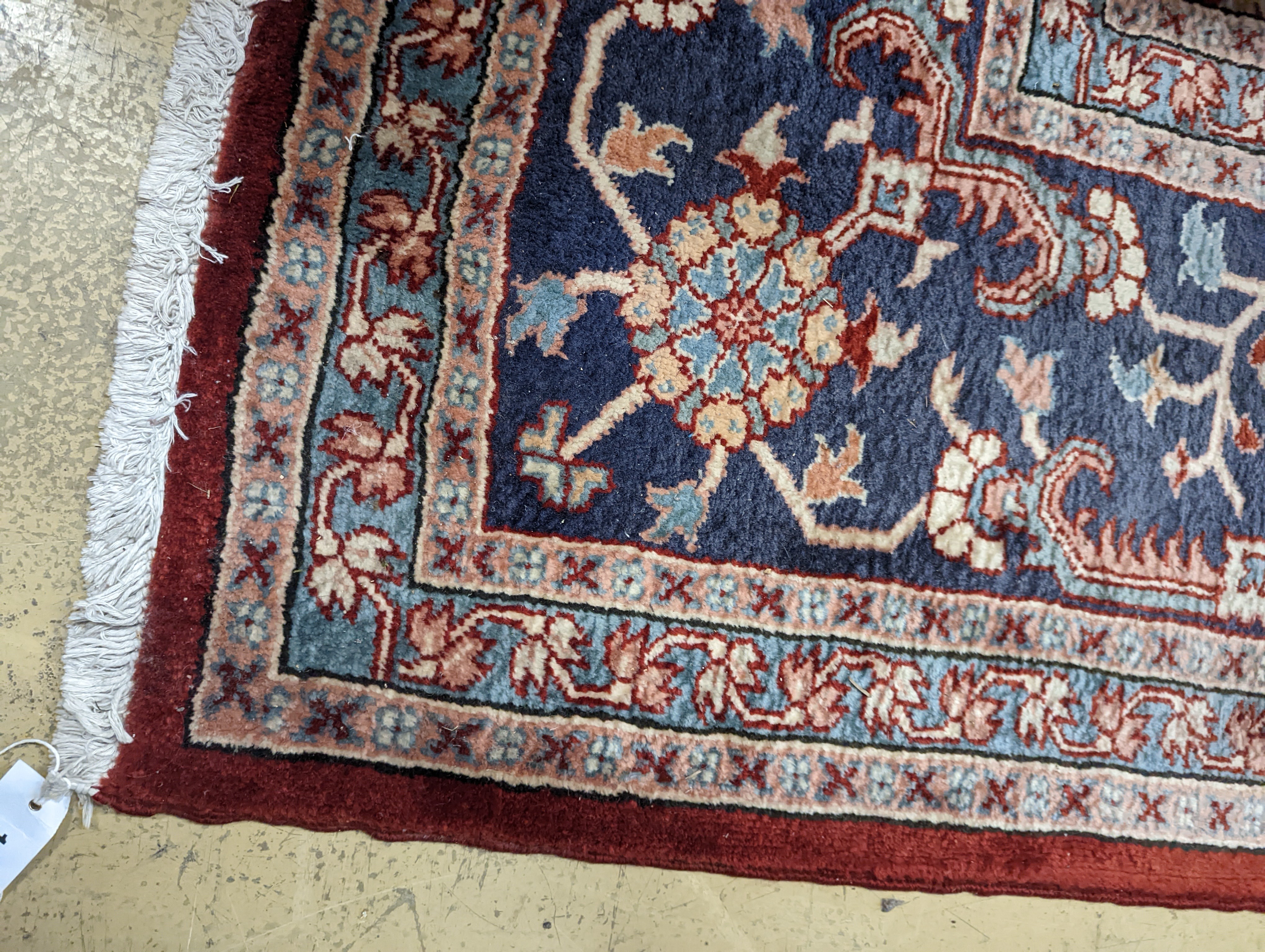 A large Caucasian style red ground carpet, 460 x 330cm